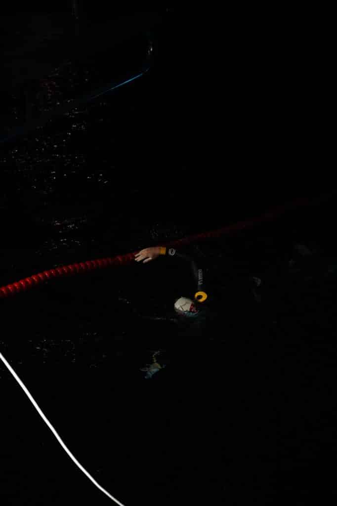 Swiss swimmer Noam Yaron at the start of his swim between Calvi and Monaco in a wetsuit behind his support boat.