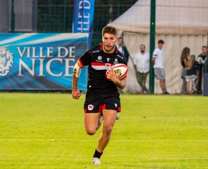 Un joueur de Nissa Rugby lancé ballon en main.