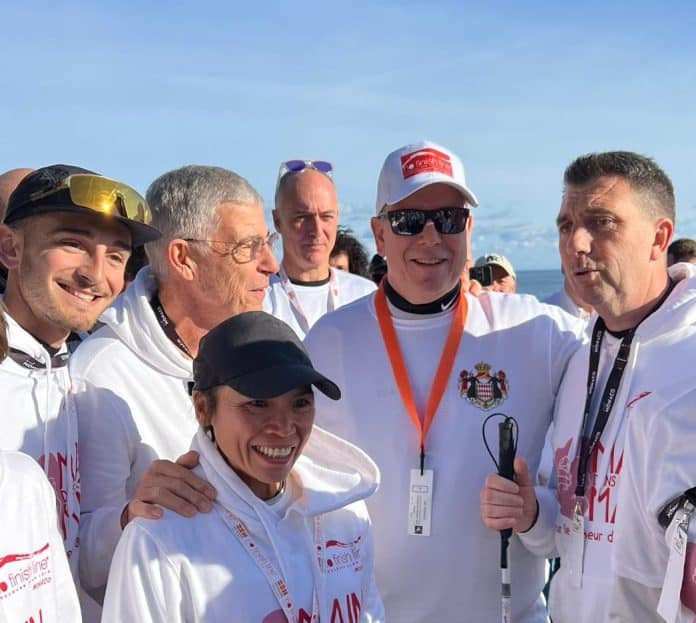 Main dans la main No Finish Line Monaco Le Prince Albert de Monaco au côté des participants à la No Finish Line de l'association ANICES Main dans la main en tenue blanche.