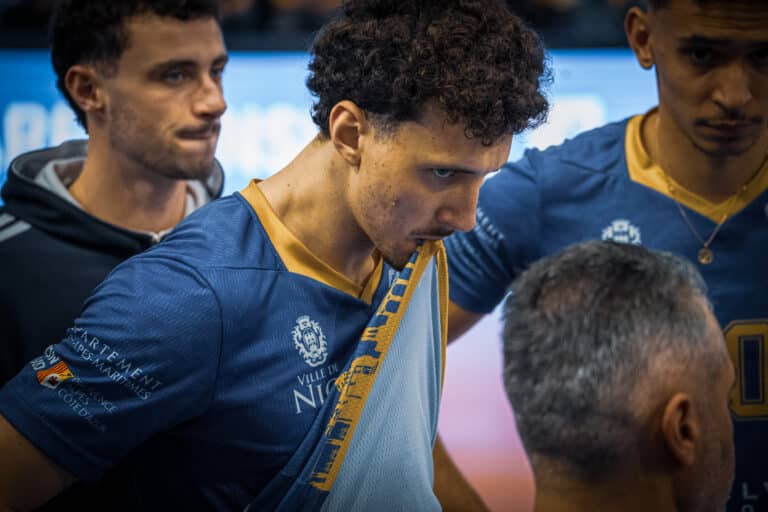 Une joueur du Nice Volley Ball tire son maillot bleu avec la bouche visiblement déçu.