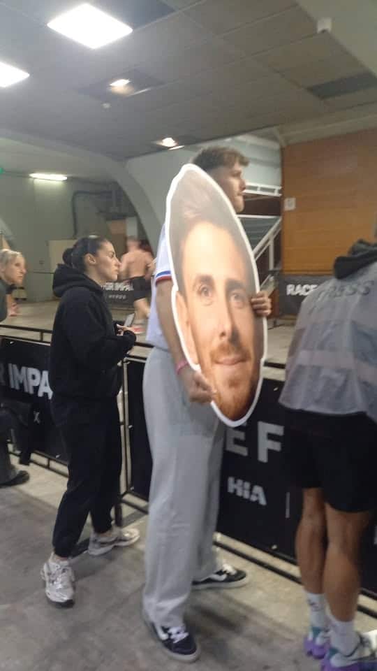 a giant head sign of the athlete Tommy Valentin held by his friend