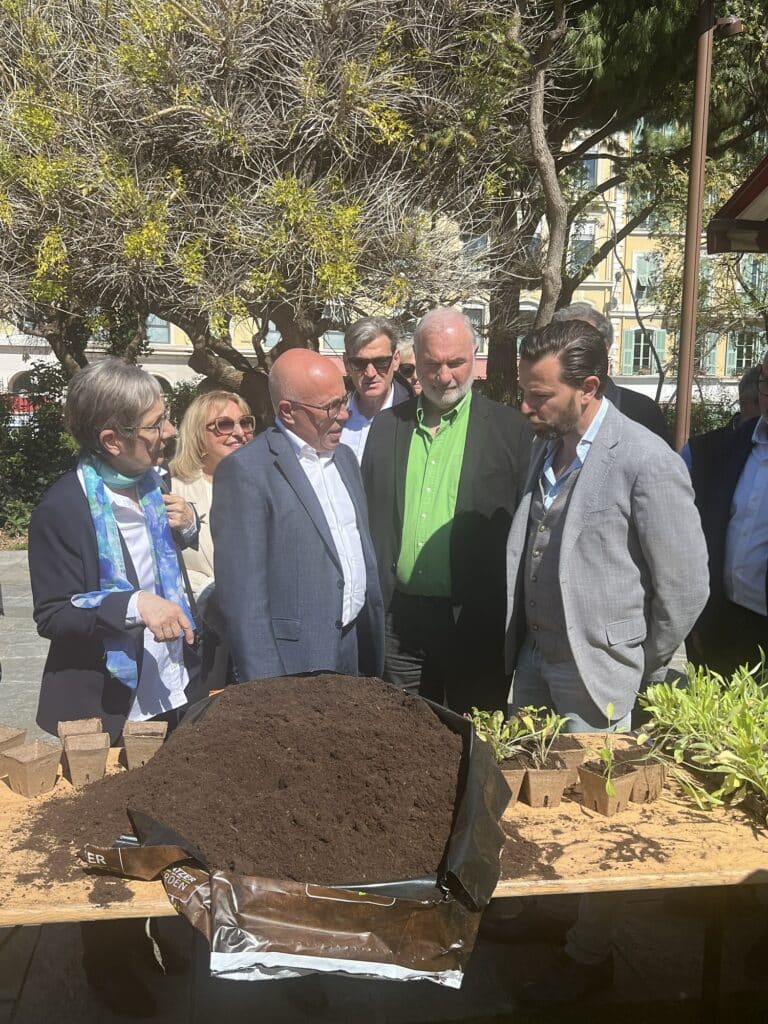 Eric Ciotti talking with residents alongside elected officials amid the vegetation installed on the Promenade du Paillon.