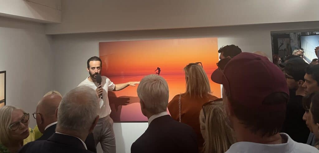 Mathieu forget présentant son art (photographie sur un lac) au public
